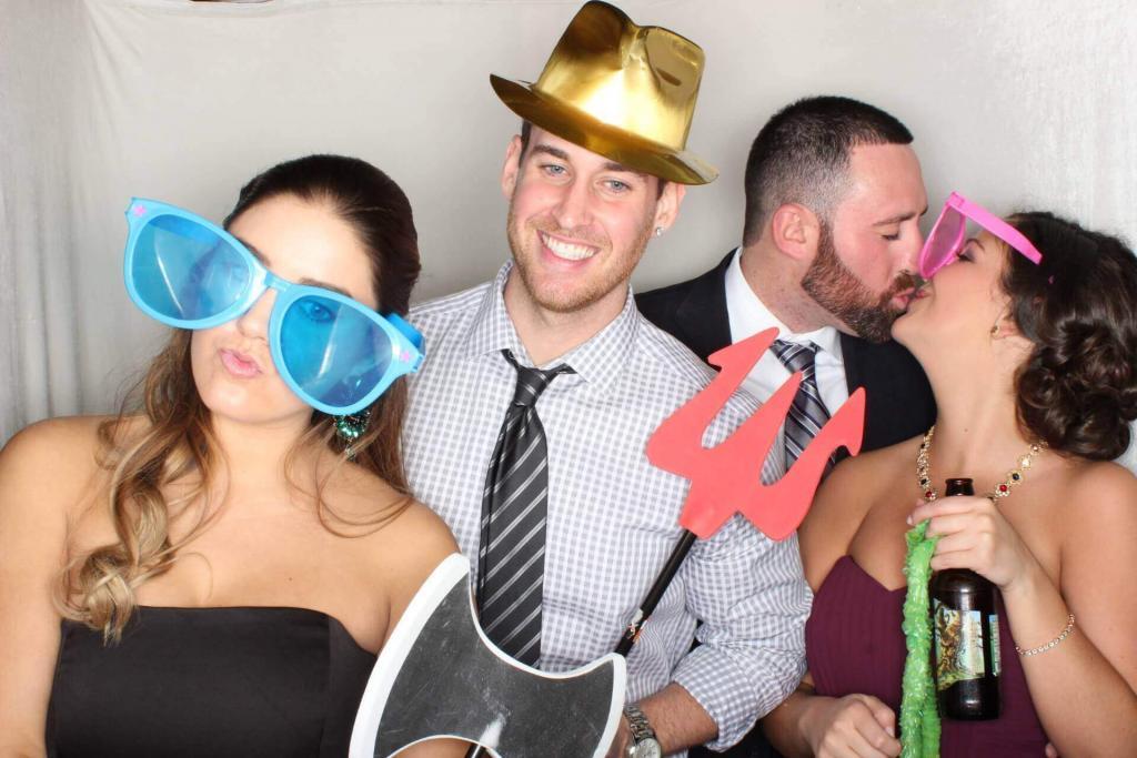 people with masks and hats in photo booth