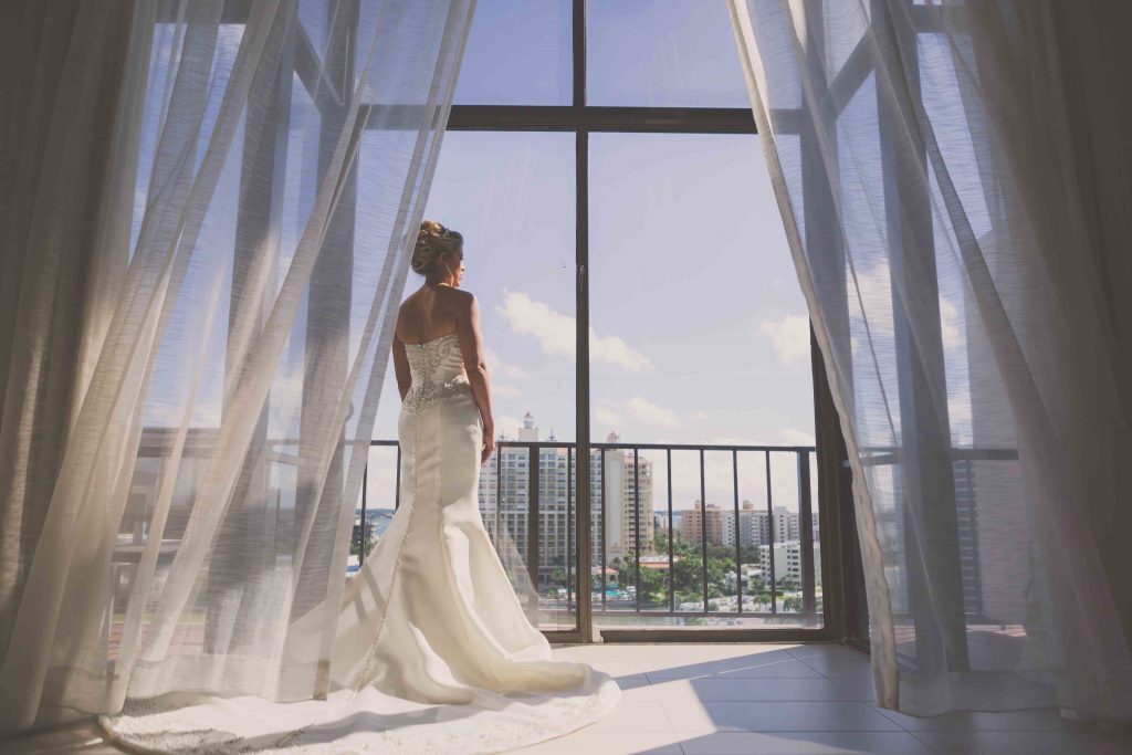 bride standing by the panoramic window
