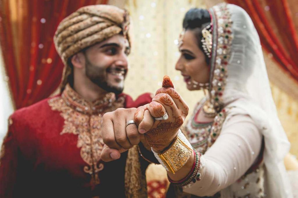 indian wedding couple holding hands