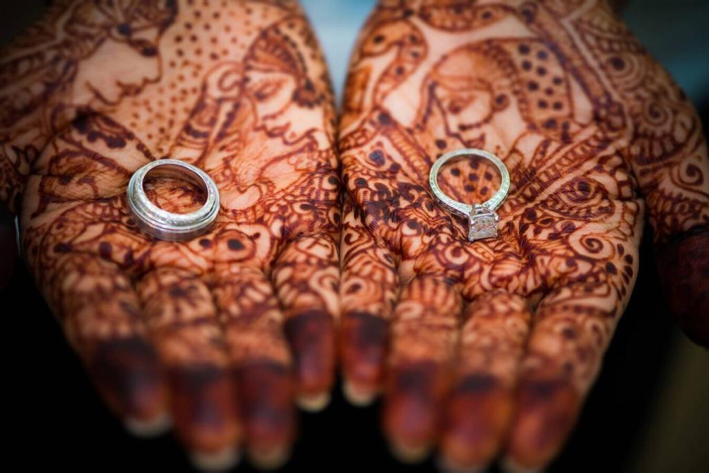 indian bride holding wedding rings