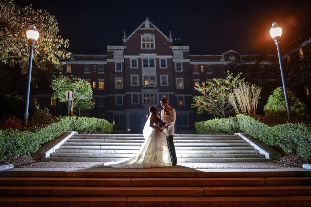 night photo of wedding couple standing o nthe steps