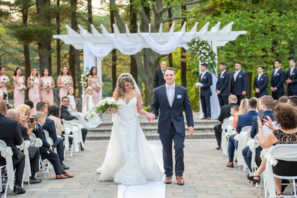 happy groom and bride near wedding venue East Brunswick