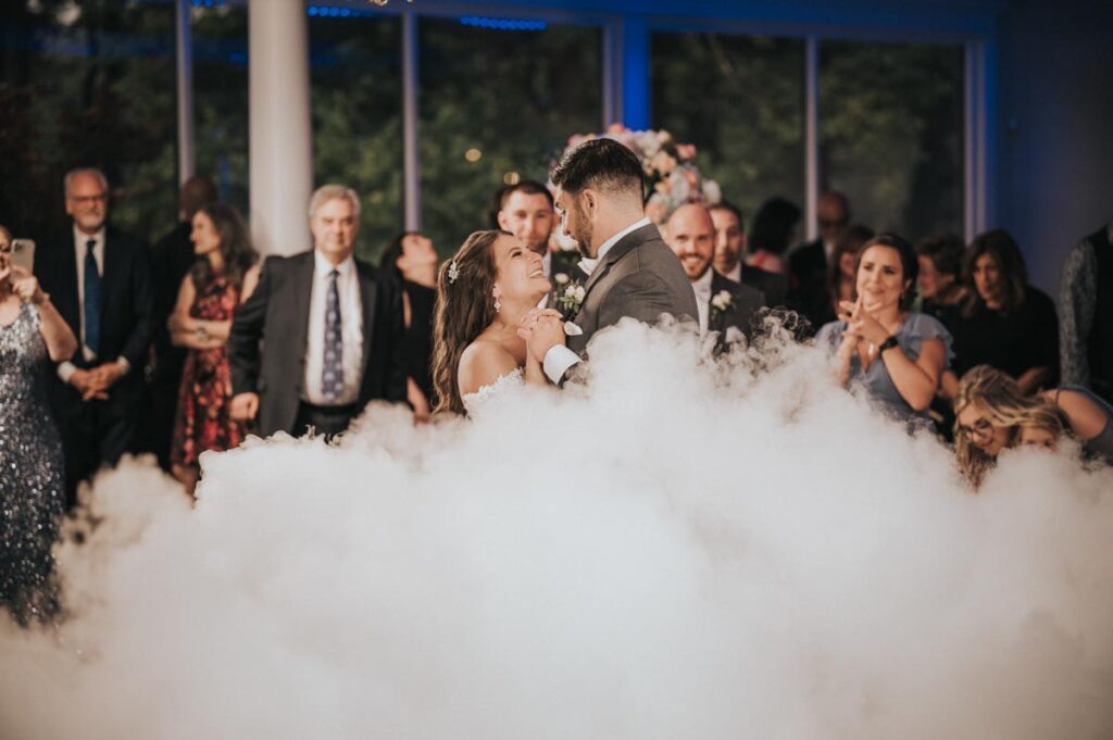 Happy Newlyweds kissing during dancing