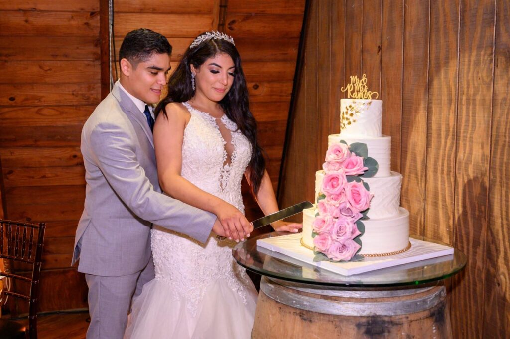 happy newlyweds near wedding cake at Perona Farms, NJ