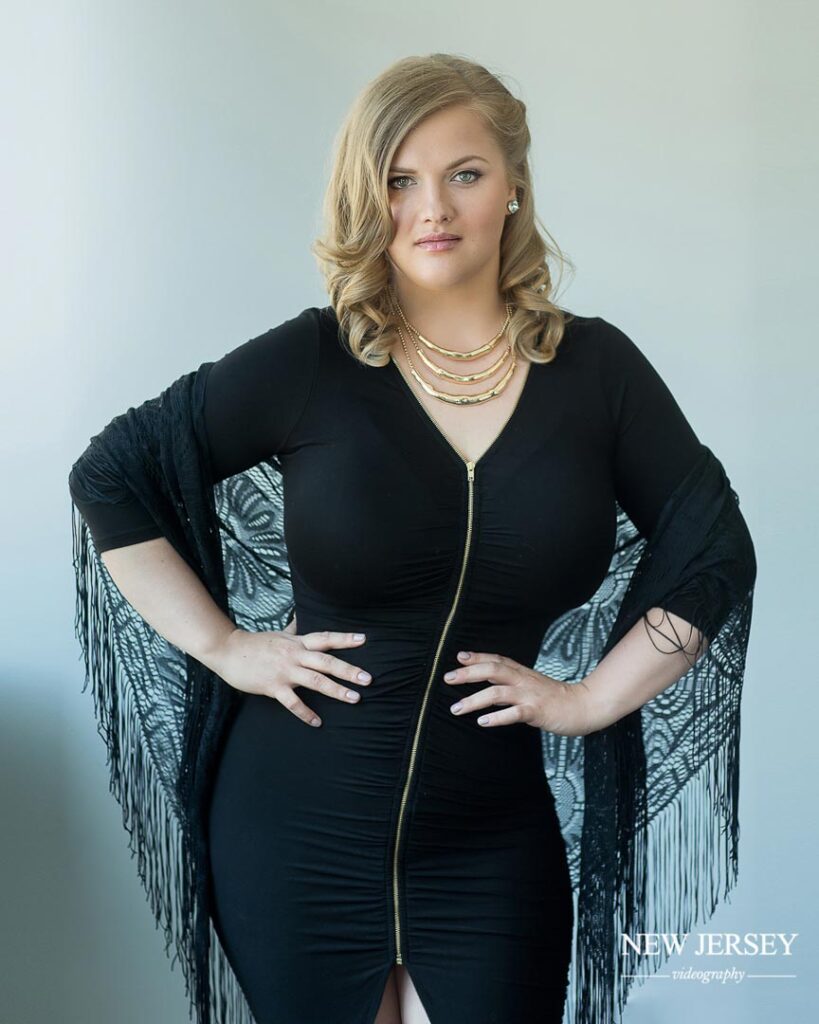 portrait of a blonde woman in a black dress