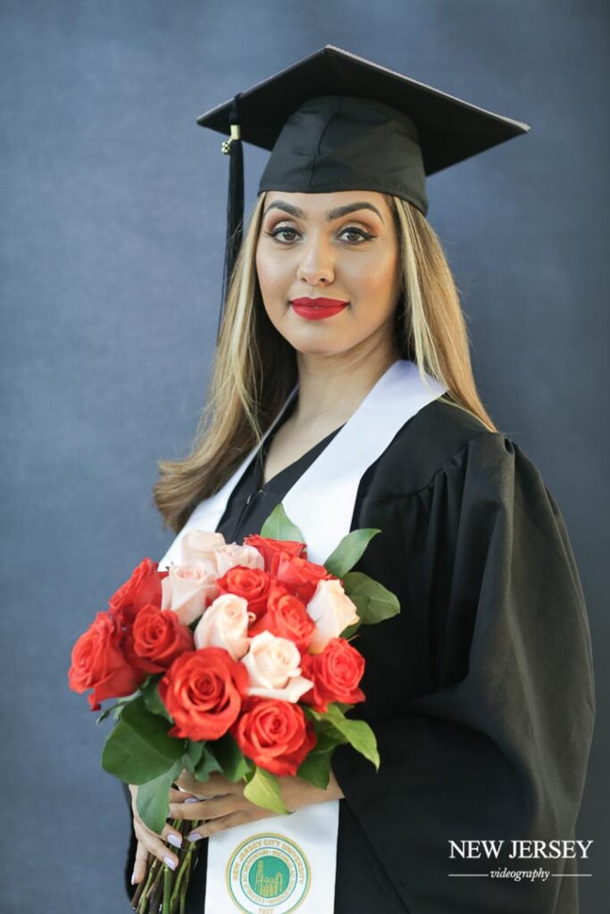 graduate holding flowers