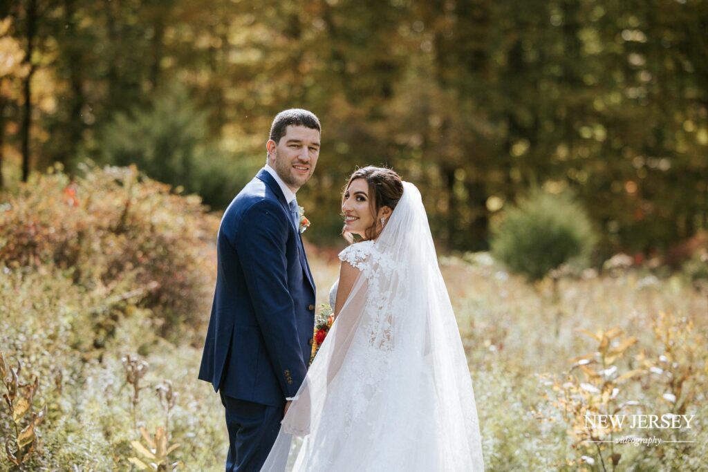 groom and bride having photoshoot in park in new jersey