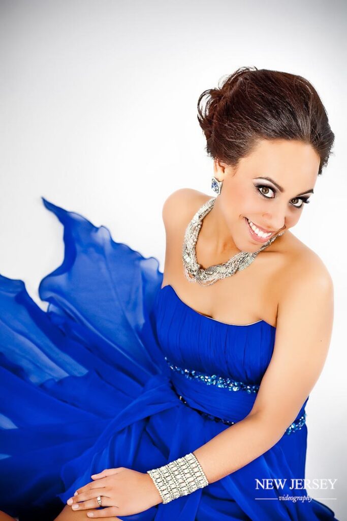 portrait of a smiling woman in a blue dress