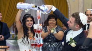 groom and bride pouring champagne in glasses